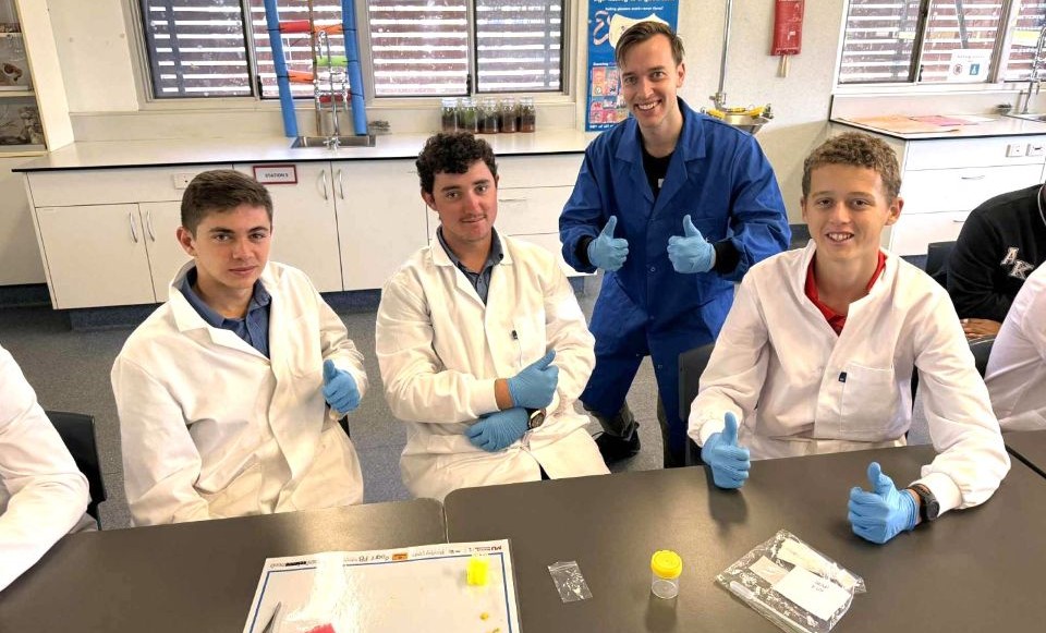 St Marys College Broome students sitting at a table thumbs uo