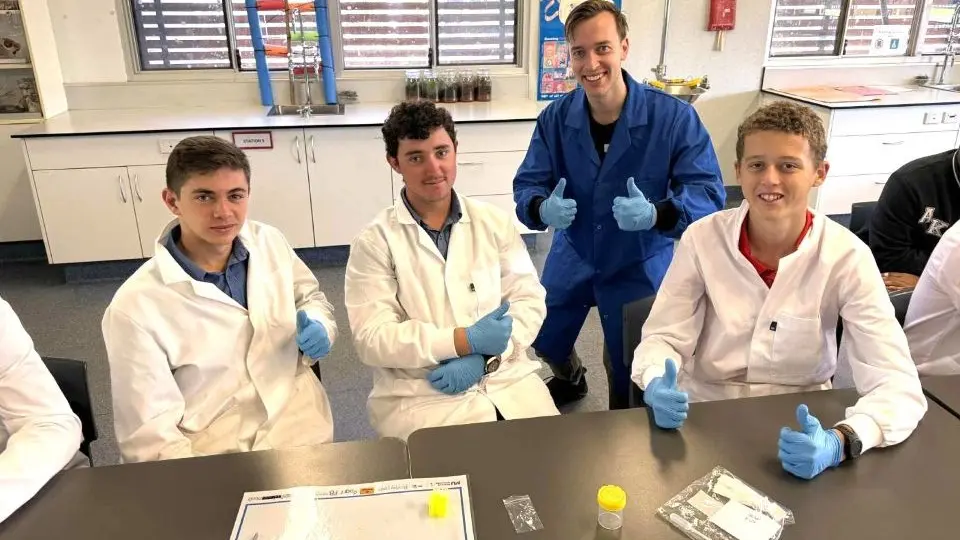 St Marys College Broome students sitting at a table thumbs uo