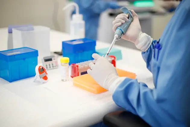 Researcher using pipette