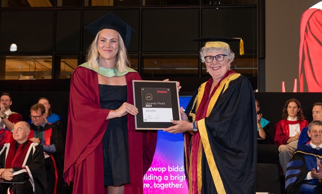 Joey Lee Paul from Chiropractic receiving her University Medal from the Chancellor