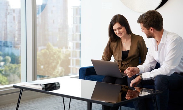 business students working with laptop