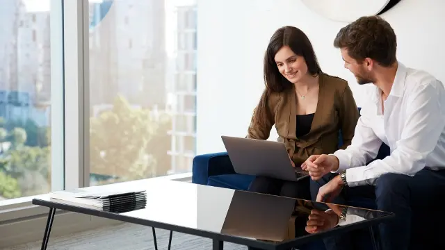 business students working with laptop