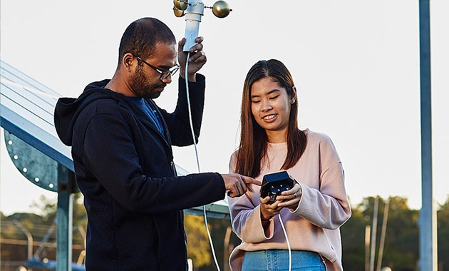 2 students with measurement equipment