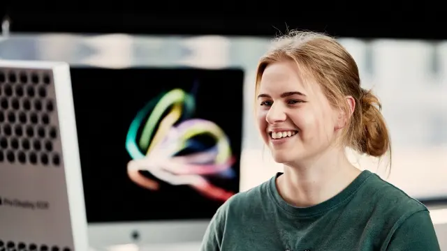 Woman at computer, smiling