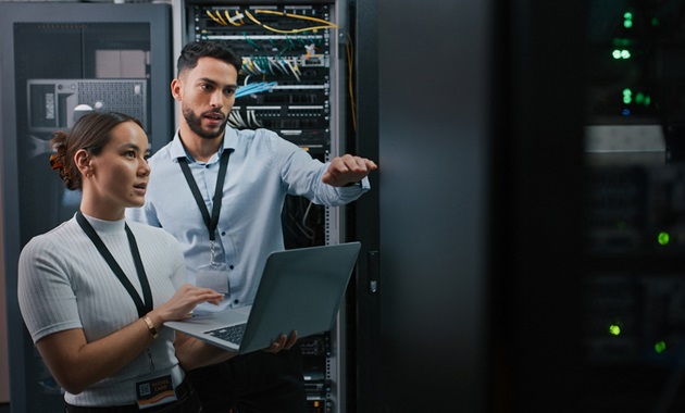 two staff looking at server