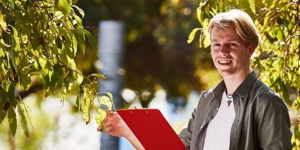 student with red clipboard