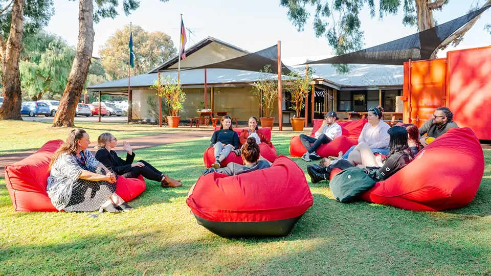 Group of people sitting on bean bags outside