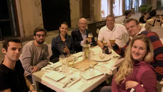 Students having outdoor dinner in Italy