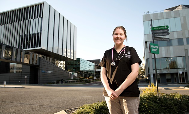 Female nursing student in front of hospital