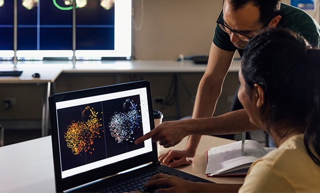 2 people looking at a screen with results