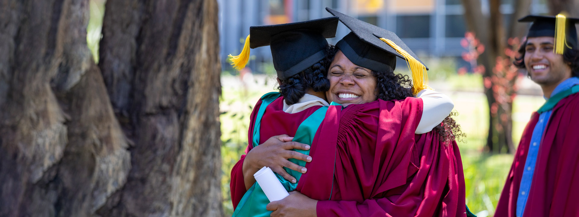 Graduates happily hugging
